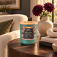 Bourbon Coffee 12 oz soy candle in a matte green glass jar with a crackling wood wick and engraved wood lid